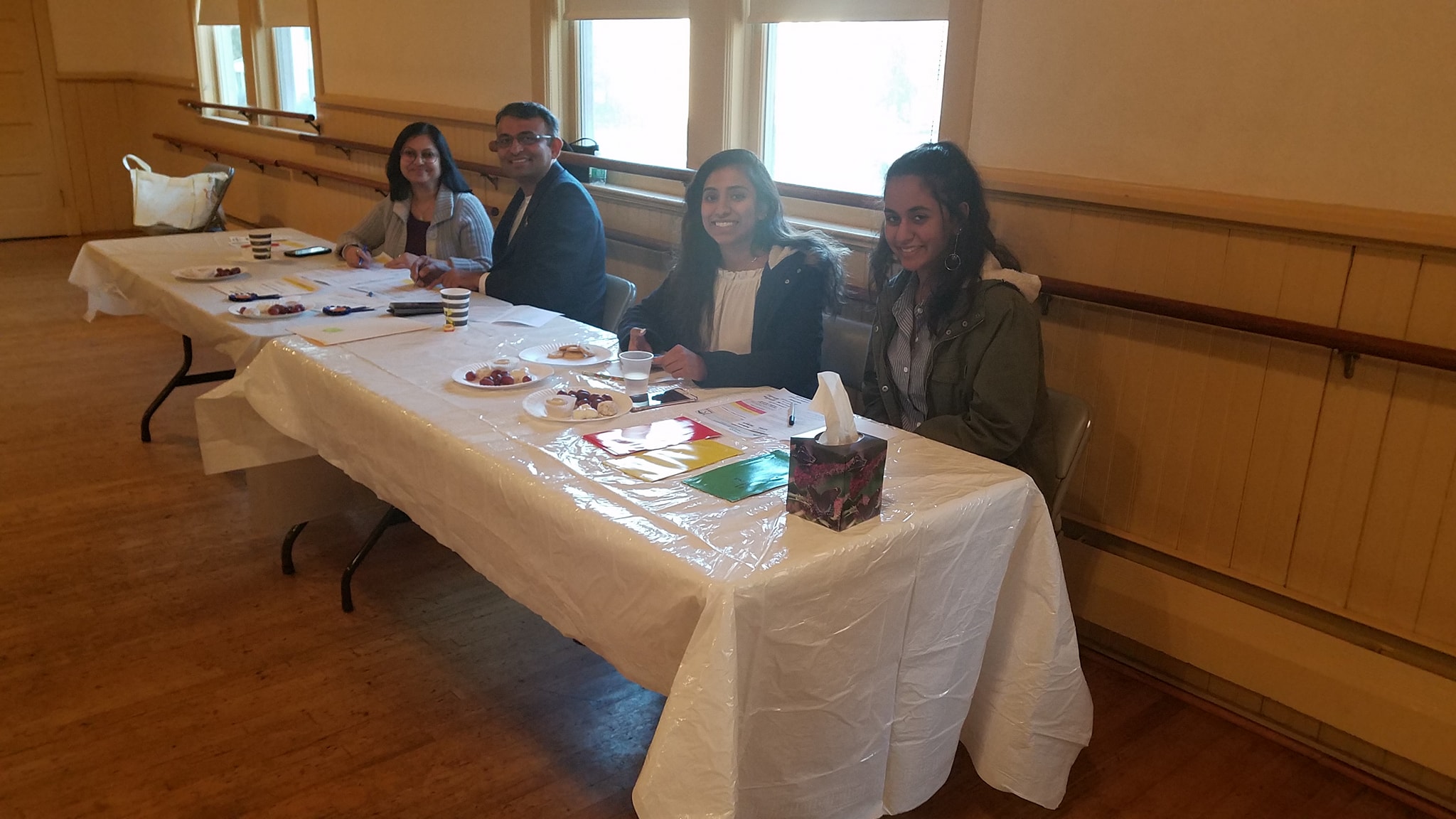 Four guest judges seated at a long table with ballots and score sheets at a DSI event